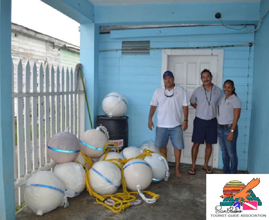 Tour guide association members with donated marine equipment